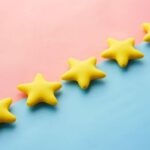 Feedback - a row of yellow stars sitting on top of a blue and pink surface